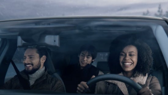 Three passengers riding in a vehicle and smiling | Mankato Nissan in Mankato MN